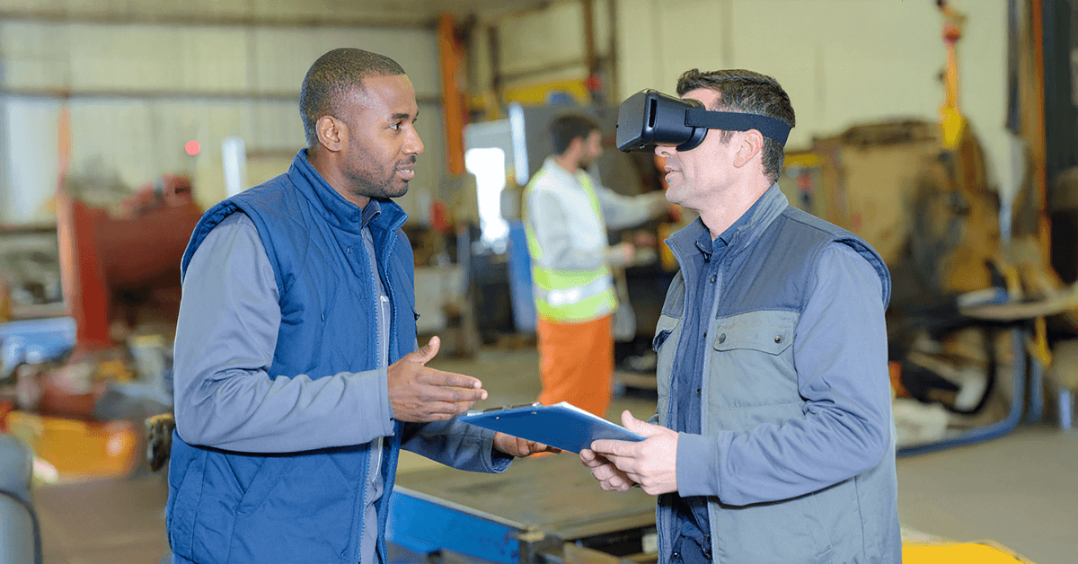 man in blue shirt giving vr training demo inside the factory